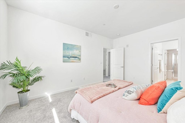 carpeted bedroom featuring ensuite bathroom