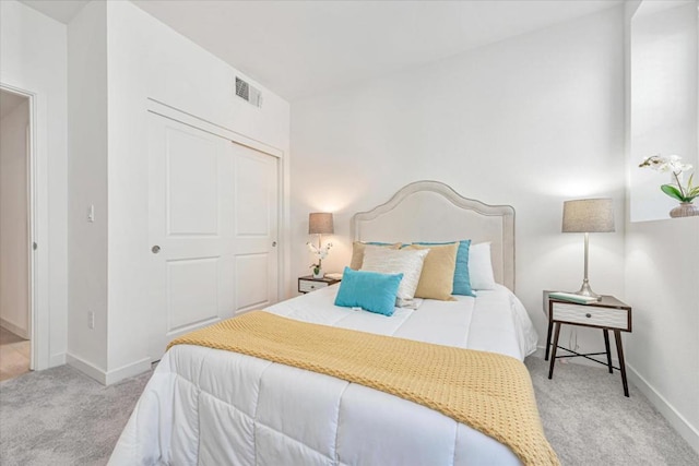 bedroom with a closet and light carpet