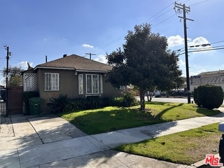 view of side of home featuring a lawn