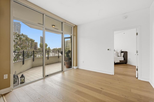 empty room featuring baseboards and light wood-style floors