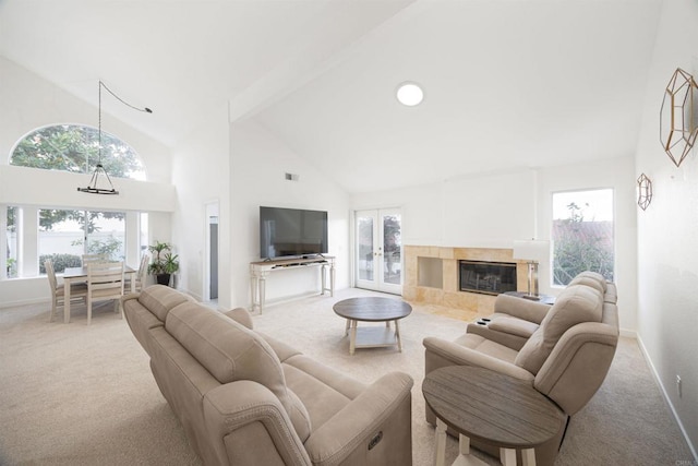 carpeted living room featuring a fireplace, high vaulted ceiling, french doors, and beamed ceiling