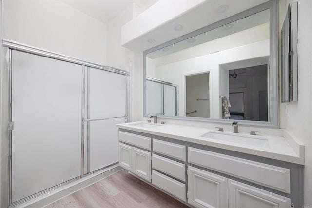 bathroom featuring vanity, a shower with door, and hardwood / wood-style floors