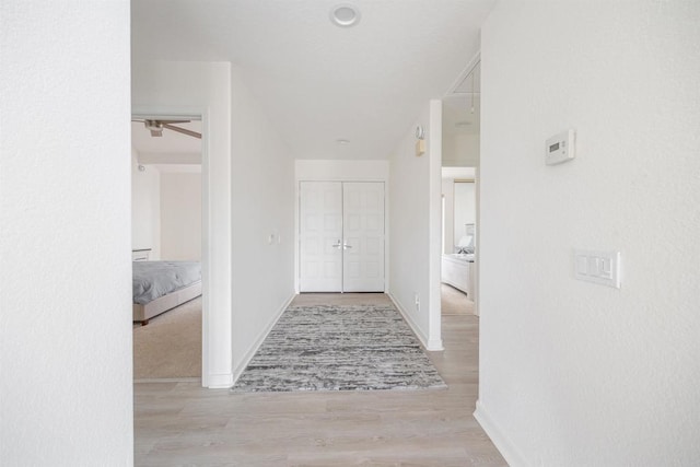 hallway with light hardwood / wood-style flooring