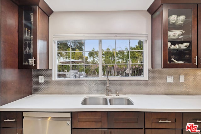 kitchen with dark brown cabinetry, sink, tasteful backsplash, and dishwasher