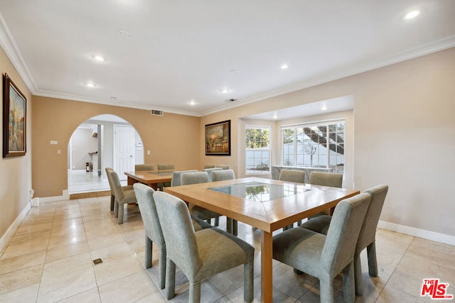 dining room with ornamental molding and light tile patterned floors