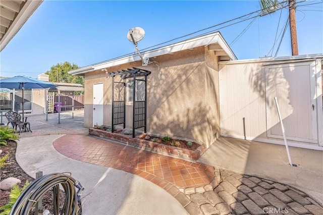 doorway to property with a patio area