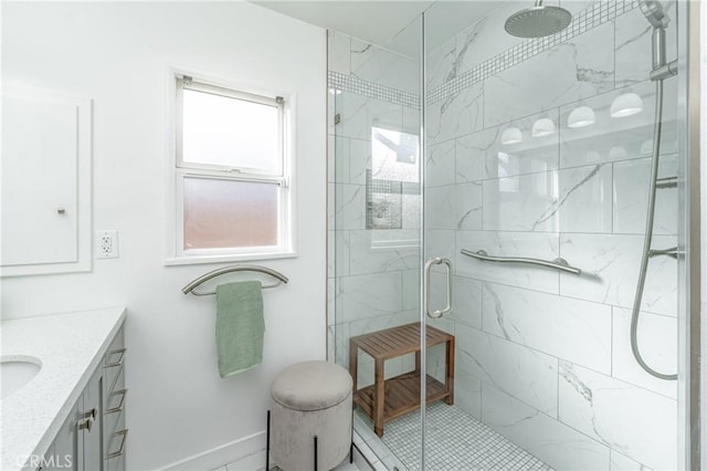 bathroom with vanity and a shower with shower door