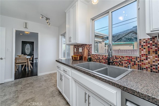 kitchen with sink, decorative backsplash, and white cabinets