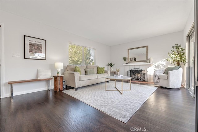 living room featuring dark hardwood / wood-style floors and a fireplace