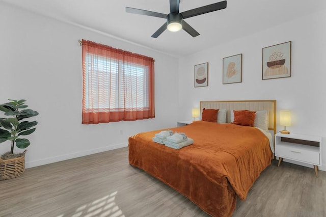 bedroom featuring ceiling fan and light hardwood / wood-style flooring