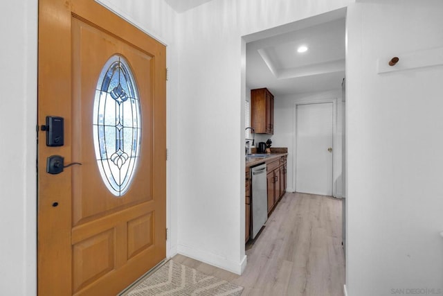 entrance foyer with sink and light hardwood / wood-style flooring