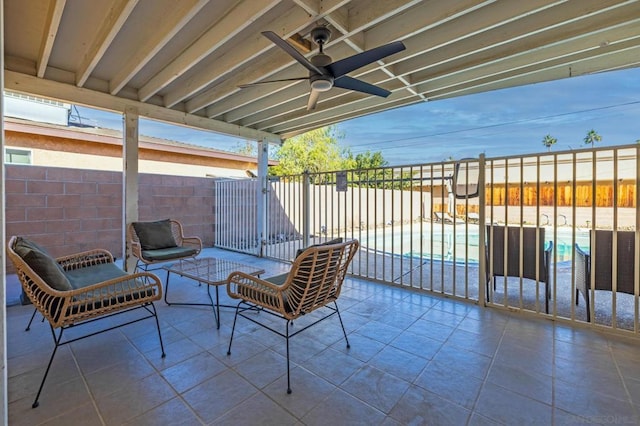 view of patio / terrace with a fenced in pool and ceiling fan