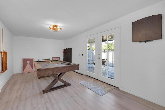 recreation room with billiards, light hardwood / wood-style flooring, and french doors