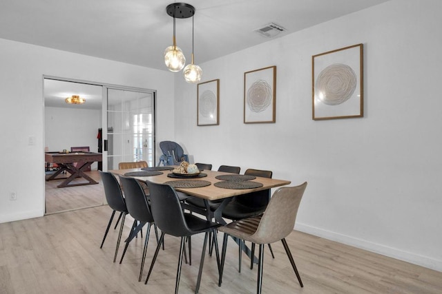 dining area with light hardwood / wood-style floors