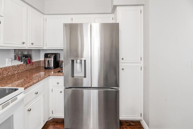 kitchen with stainless steel refrigerator with ice dispenser, white cabinetry, stone countertops, and white range with electric cooktop