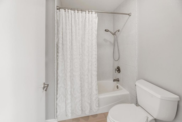 bathroom with shower / bath combination with curtain and toilet