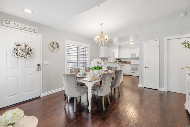 dining space with dark wood-type flooring and a chandelier