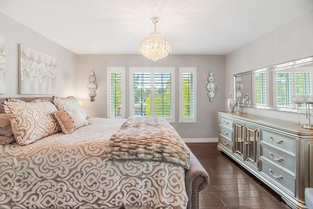 bedroom with dark wood-type flooring and an inviting chandelier