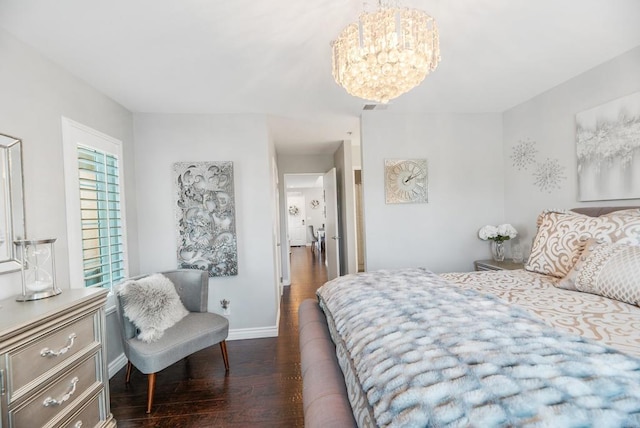 bedroom featuring a chandelier and dark hardwood / wood-style flooring