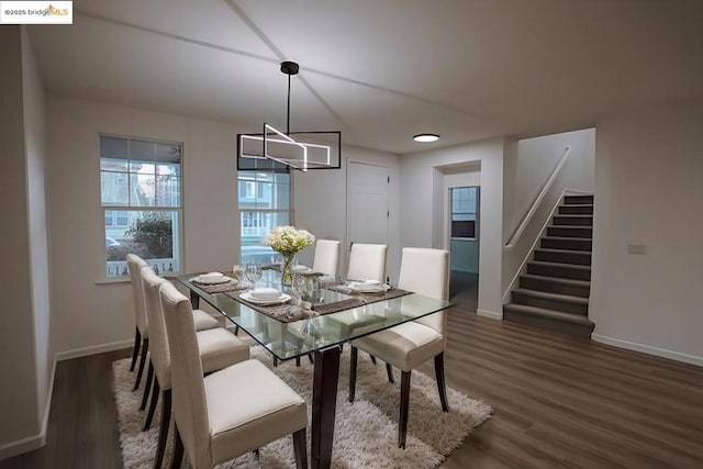 dining area featuring dark wood-type flooring