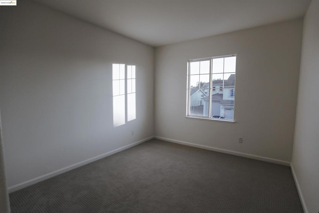 empty room with dark carpet