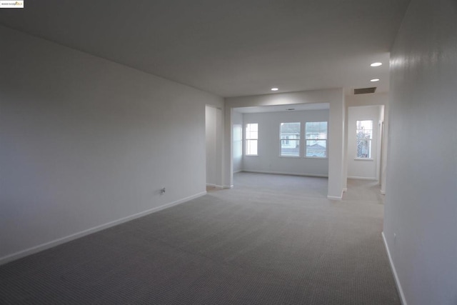 unfurnished room with light colored carpet