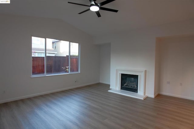 unfurnished living room featuring wood-type flooring, vaulted ceiling, and ceiling fan