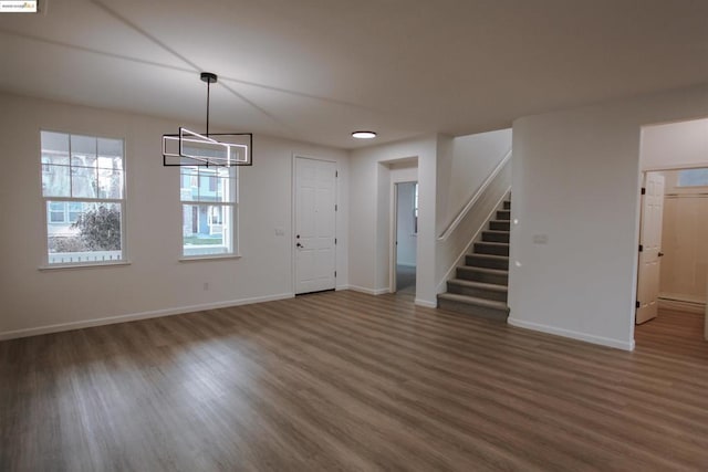 interior space featuring dark hardwood / wood-style flooring and a chandelier