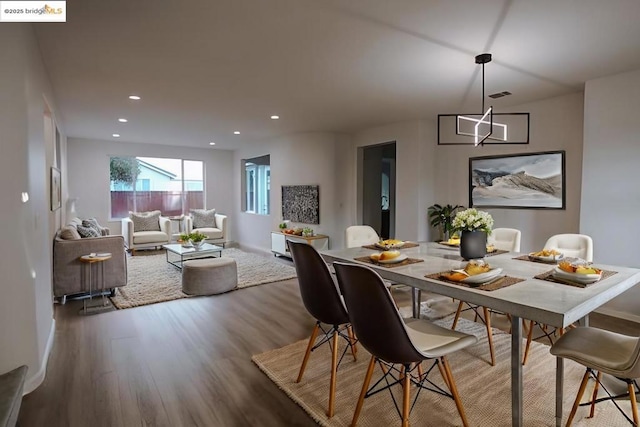 dining space with hardwood / wood-style floors