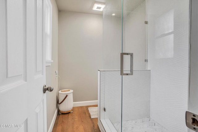 bathroom featuring wood-type flooring and a shower with door