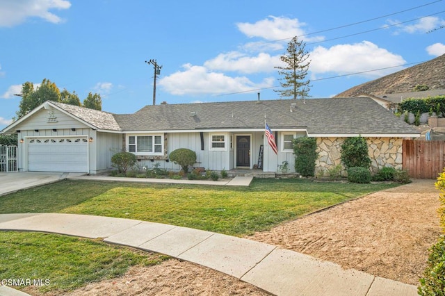 ranch-style home with a garage and a front lawn