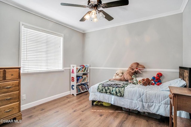 bedroom featuring crown molding, light hardwood / wood-style flooring, and ceiling fan