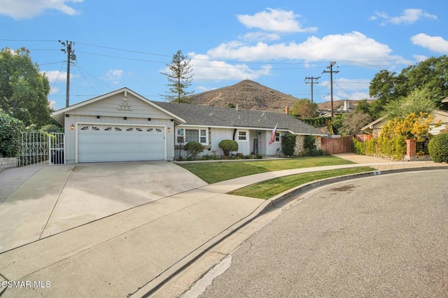 ranch-style home featuring a garage and a front lawn