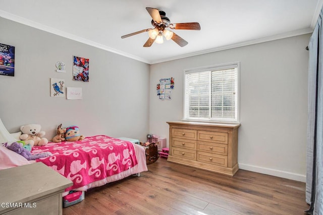 bedroom with crown molding, ceiling fan, and wood-type flooring