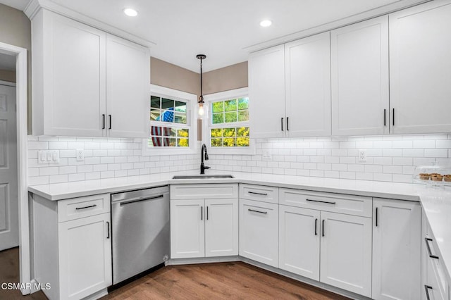 kitchen with pendant lighting, sink, dishwasher, white cabinetry, and wood-type flooring