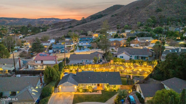 aerial view at dusk featuring a mountain view