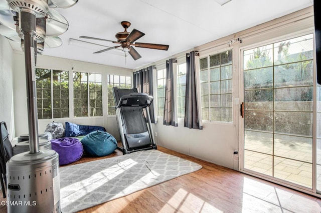 exercise room with hardwood / wood-style flooring, ceiling fan, and a wealth of natural light