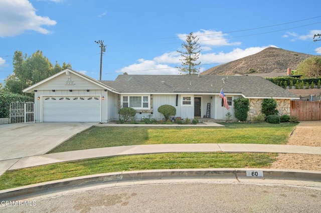 ranch-style home with a garage and a front yard