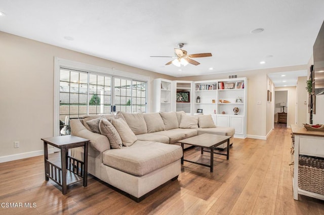 living room featuring ceiling fan and light hardwood / wood-style flooring