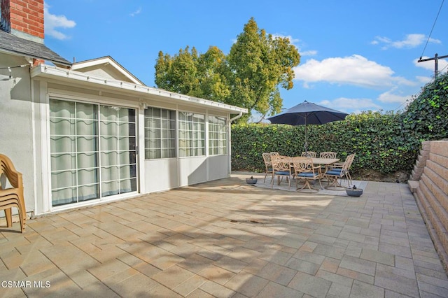 view of patio / terrace featuring a sunroom