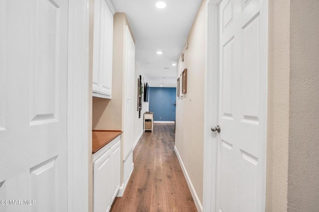 hall with hardwood / wood-style flooring