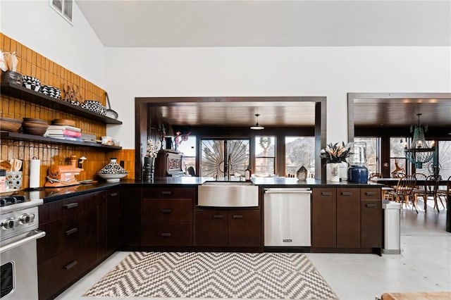 kitchen with dark brown cabinets, sink, and stainless steel range