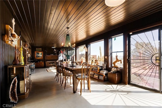 dining space featuring an inviting chandelier and wooden ceiling