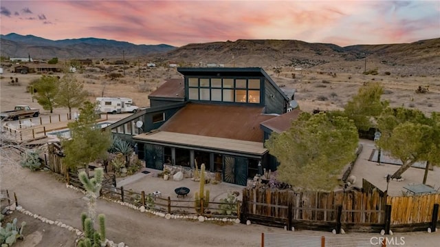 back house at dusk featuring a mountain view