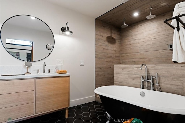 bathroom featuring vanity, tile patterned flooring, and a washtub