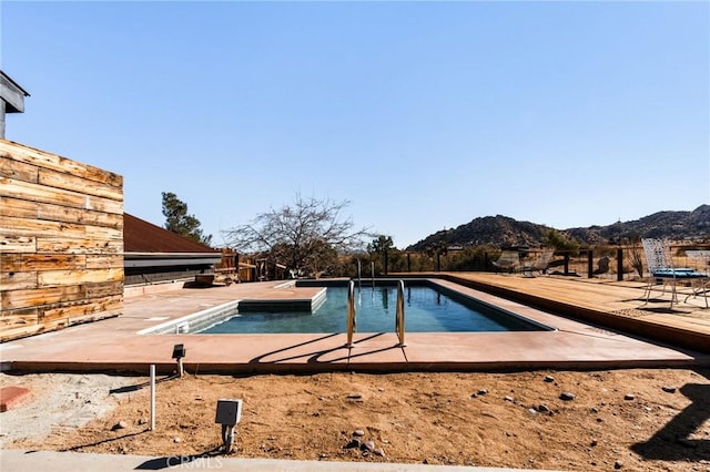 view of pool featuring a mountain view and a patio