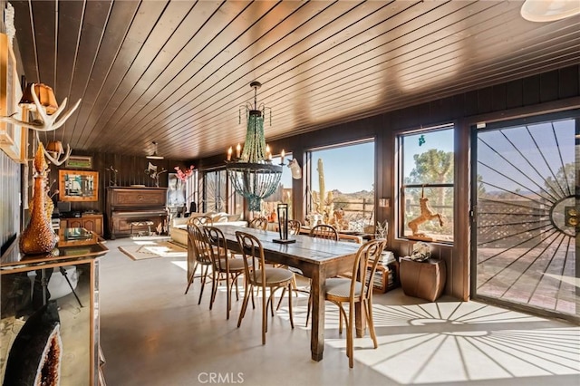 sunroom / solarium with wooden ceiling and a notable chandelier