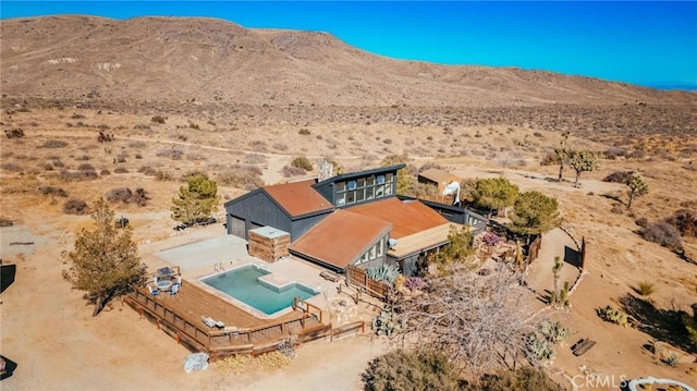 birds eye view of property featuring a mountain view