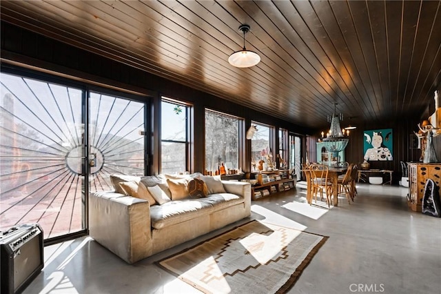 sunroom with an inviting chandelier, heating unit, and wooden ceiling