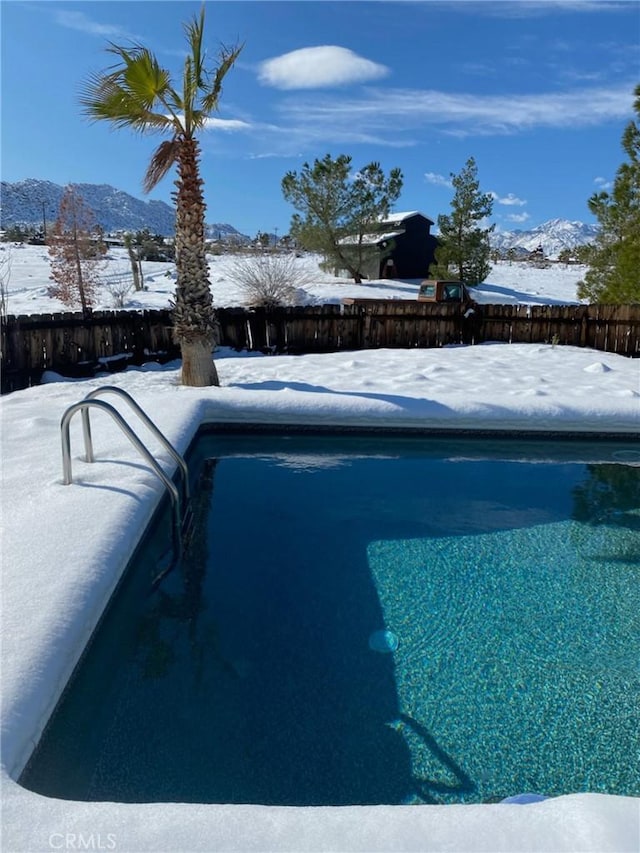 snow covered pool with a mountain view